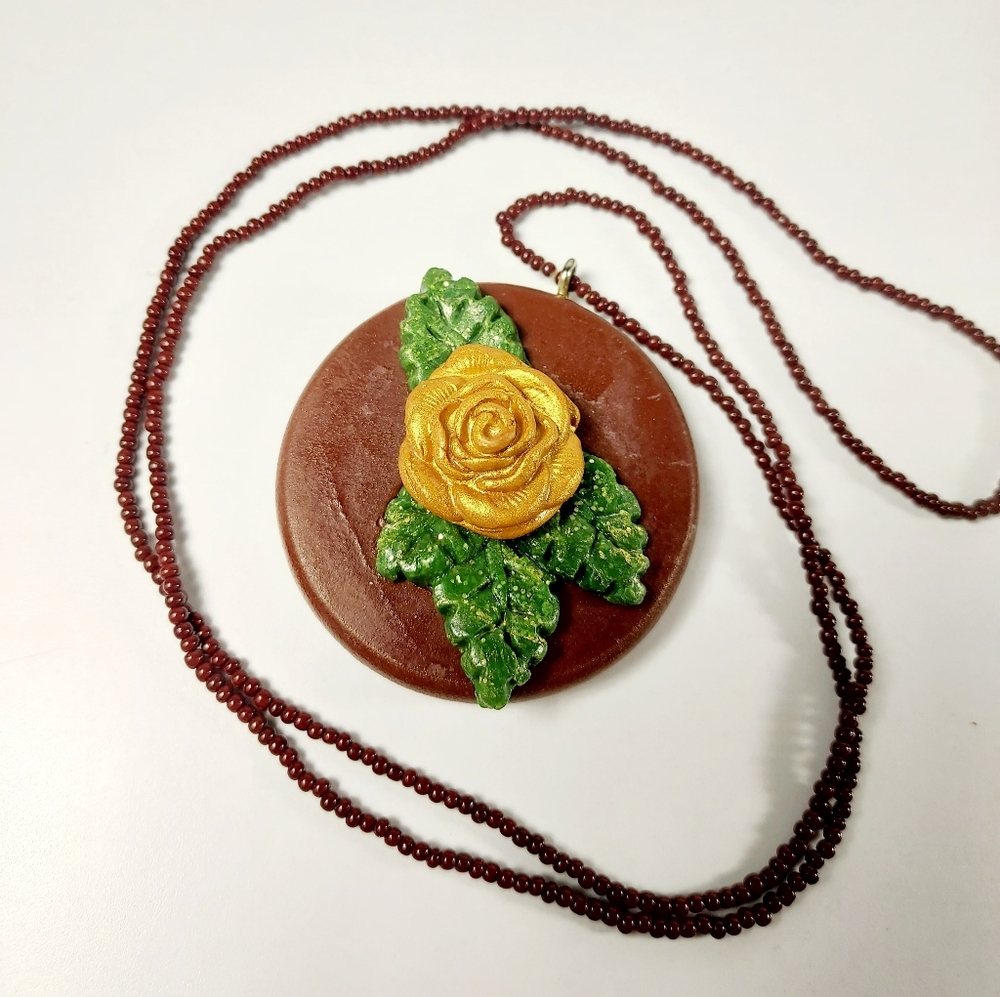 Maroon Seed Beaded Wood Pendant Necklace with Gold Rose and forest Green Leaves